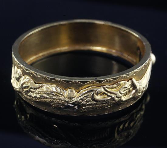 A Chinese high carat gold hinged bangle,